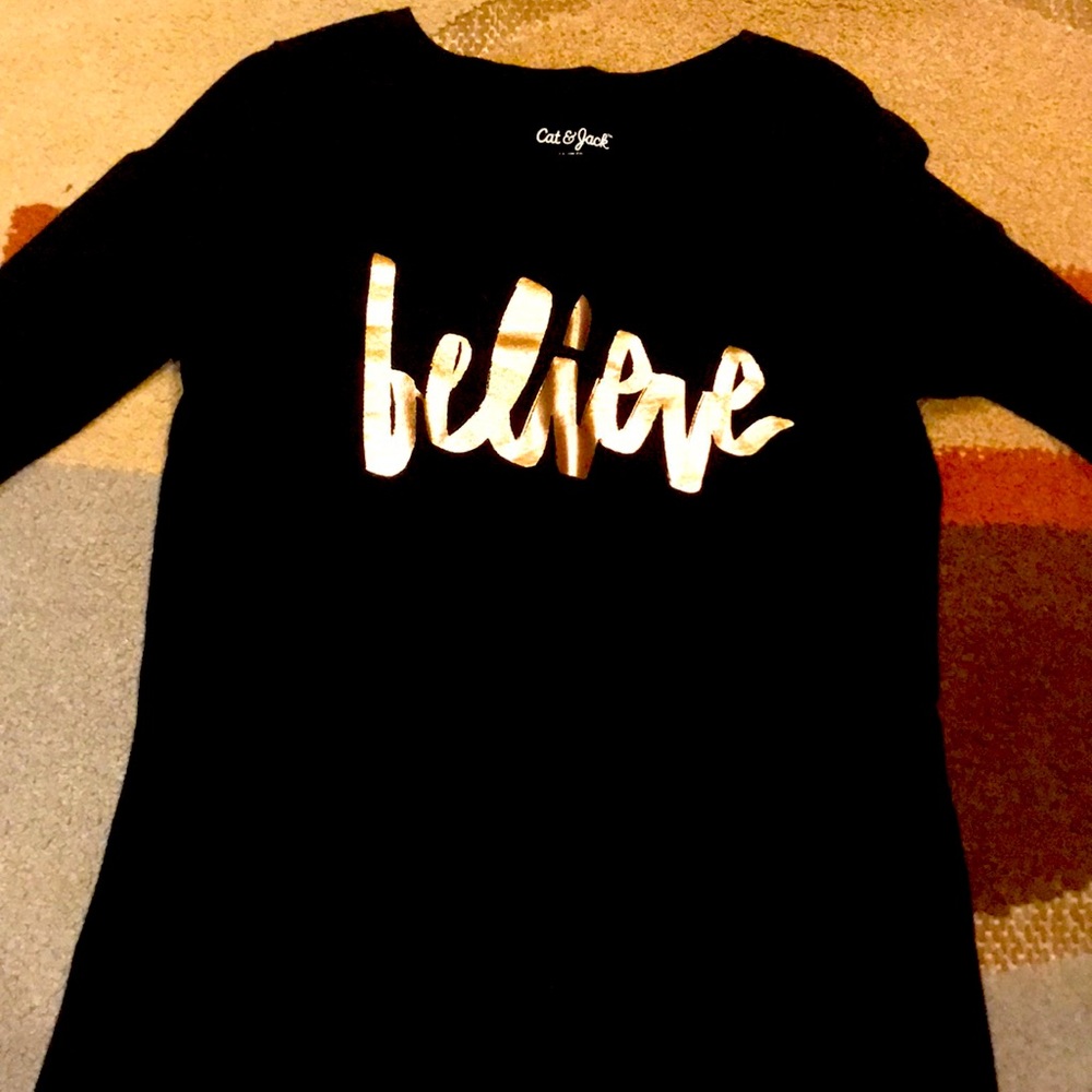 Black shirt that says believe